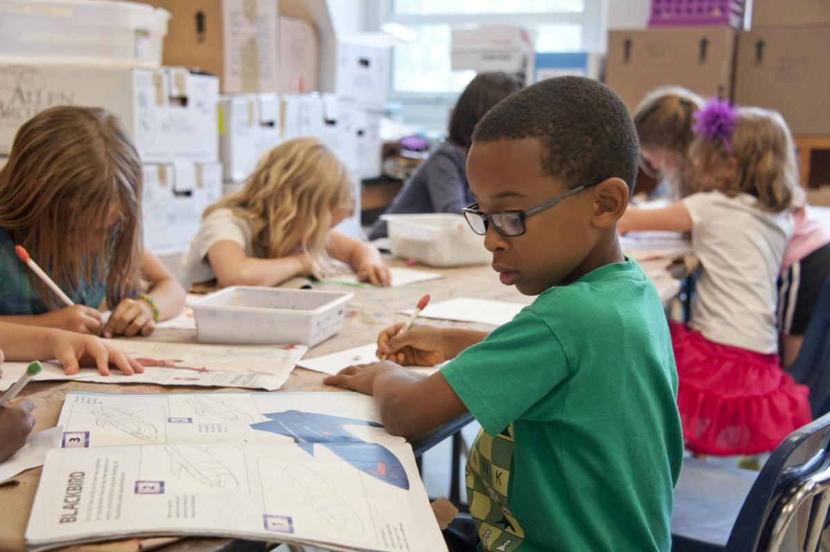 School child sitting at desk working