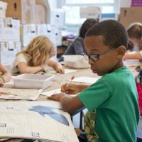 School child sitting at desk working