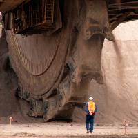 large mining machine with worker in foreground